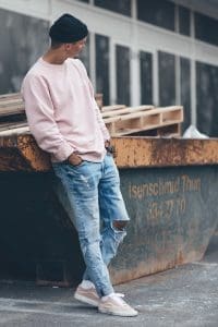 male model wearing a pink sweater male model wearing a pink sweater